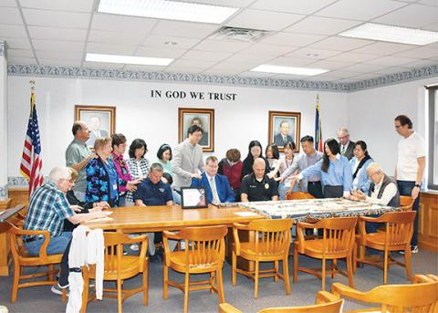 Anngee Quinones-Belian/Staff Correspondent  Korean Prayer Ambassadors prayed for and over Al Lovingood, chief of the Murphy Fire Department; Mayor Tim Radford; and Tim Lominac, chief of the Murphy Police Department, on Thursday at Murphy City Hall. The prayers were for them, their leadership rolls in the community as well as the members of their departments.