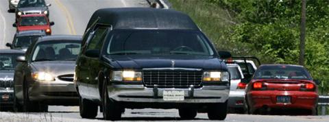 A local tradition is to show respect for the deceased by pulling to the right and stopping as a funeral procession passes. Failing to do so labels one quickly as disrespectful and rude, even if that is not how it is done where you came from. You are here now. Show respect and thus receive it in return.