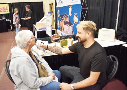 Anngee Quinones-Belian/Staff Correspondent Donna Itterly of Cornelia, Ga., (left) receives a skin smoothing treatment on April 27 from Giovanni, a representative of Spades Cosmetics, during the annual Northeast Georgia Home & Garden Show in Blairsville, Ga.