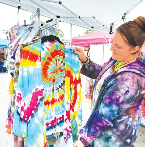 Photos by Anngee Quinones-Belian/Staff Correspondent  Passersby couldn’t miss the colorful clothing on display by Vanessa Miller with Twizted Dyes during the Murphy Spring Festival in May 2022. Her clothing offered eye-catching designs, with no shortage of folks browsing her booth.