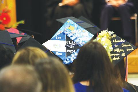 Cannon Crompton/sports@cherokeescout.com One of the decorated graduation caps at Tri-County Early College on Friday signifies that she is a first-generation high school graduate from El Salvador.