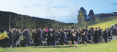 J.R. Carroll/Staff Correspondent Murphy High School’s latest group of senior graduates celebrate with a gold confetti bath Friday night after being awarded their diplomas at Bob Hendrix Stadium.