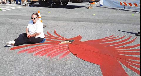 Photos by Anngee Quinones-Belian/Staff Correspondent  A beautiful cardinal adorned Tennessee Street in downtown Murphy on May 11 during the annual Spring Festival. The street art was created by Jessica Beegle of Ranger using colored chalk. She travels around the country drawing for special events. Her cardinal and dogwood flower drawing was in honor of spring. She has been drawing with chalk for about 10 years.