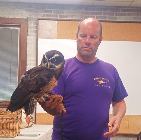 Photos by Nicole Wright/Staff Correspondent Tom Bennett from the North Georgia Wildlife Park holds “Specks,” a spectacled owl.