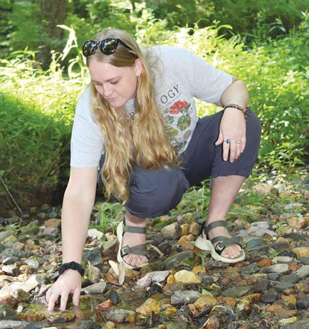 Stacy Van Buskirk/Staff Correspondent Taylor Ruf of Murphy likes to forage around a creek in her backyard that runs into the Nottley River.