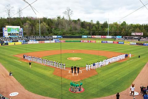 Tennessee Smokies The Tennessee Smokies (right) and the Rocket City Trash Pandas (left) stand on the field for the national anthem on opening day, April 5, at Smokies Stadium in Kodak, Tenn.