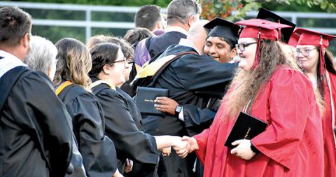 Randy Foster/editor@cherokeescout.com Andrews High School faculty congratulate newly graduated seniors Thursday night after commencement ceremonies.