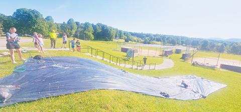 Nicole Wright/Staff Correspondent  Fifth- through eighth-grade students enjoy the slip & slide during their last Field Day on May 29. The rising sixth-graders and others will attend both Murphy middle and high schools for the 2024-25 academic year.