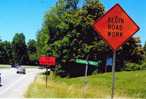 William Rau/Contributing Photographer Men at work? The N.C. Department of Transportation either put one of these signs in the wrong place in Ranger or this was the shortest road project of all time.