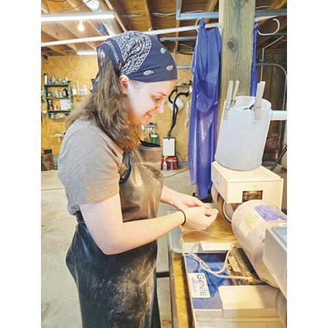 Stacy Van Buskirk/Staff Correspondent Katie Pressley of Brasstown polishes a piece of agate. The machine has nine parts and polishes the stone with grits going from 80 to 80,000. Pressley has been a lapidary artist for four years and a rockhound for most of her life.
