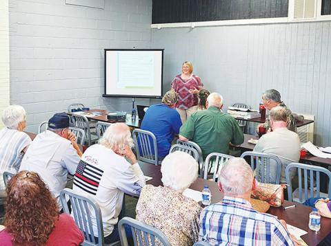 Cannon Crompton/sports@cherokeescout.com Callie Moore of MountainTrue gives a presentation on what they do to the Mountain Rod & Gun Club on July 16 at Downtown Pizza in Murphy. 