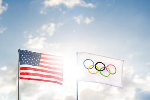 The United States flag next to the Olympic Games flag.