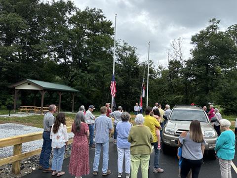 Nantahala residents gathered Saturday to raise the flags at the new Nantahala Community Library, which is also home to the Nantahala Community Development Club.