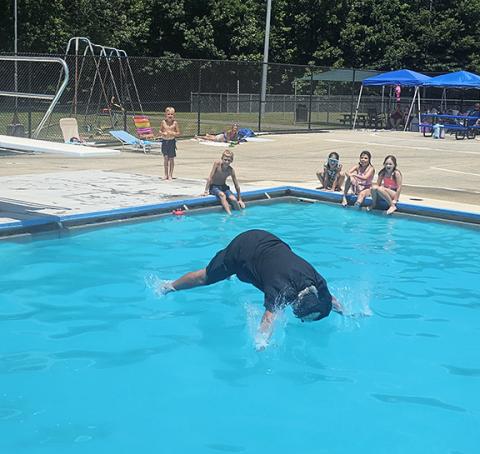 Nicole Wright/Staff Correspondent Andrews Mayor James Reid surprised the holiday crowd by participating in the annual “Belly Flop” competition, fully clothed, to whoops and hollers at the town pool.
