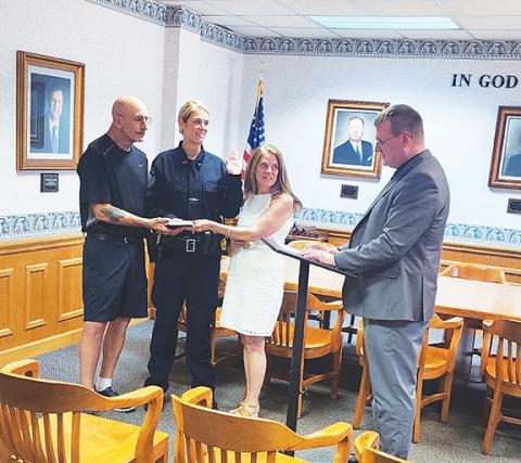 Sara Taylor, a new patrol officer with the Murphy Police Department, was sworn in on June 24 by Mayor Tim Radford. Her proud parents, Michael and Alice Attard, look on as Sara takes the oath.