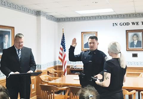 Anngee Quinones-Belian/Staff Correspondent  Murphy Mayor Tim Radford swears in new Murphy police officer Brayden Snow on July 19 at Town Hall as Snow’s girlfriend, Haleigh Helcher, looks on.