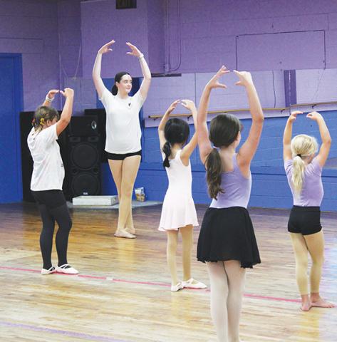 Stacy Van Buskirk/Staff Correspondent Sydnee Crubaugh, a junior at Murphy High School, leads a group of 8-10-year-olds in ballet technique, following guidance by lead instructor Gracie Prohl of Murphy.
