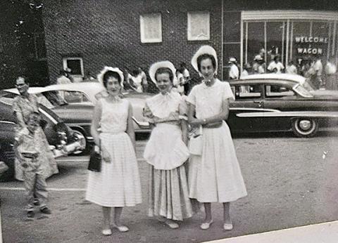 Helen McMillan (left) Roma Taylor Graham (middle) and Ruth McMillan (right) wait for the Wagon Train to pass through Murphy while dressed in pioneer attire. 