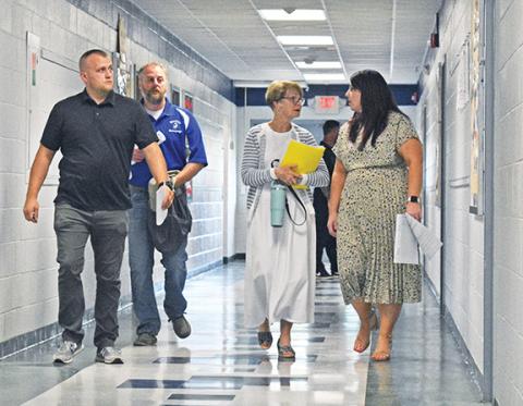 Randy Foster/editor@cherokeescout.com Four members of the Cherokee County Board of Education are shown walking down a hall before the school board meeting on Aug. 15 after meeting privately outside the Central Office building in Marble – Jason Murphy, Jeff Tatham, Jeannie Gaddis and Chair Shannon Raper (from left). The school board members met privately with Superintendent Keevin Woody, and perhaps other school board members, for at least 10 minutes, which appears to have violated North Carolina’s open meet