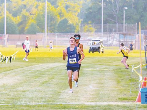 Cannon Crompton/sports@cherokeescout.com Hiwassee Dam’s Ethan Russell kicks down the final stretch to outrun Ogana Swimmer of Cherokee to secure his first win of the cross-country season in the first meet at Hayesville on Aug. 21.