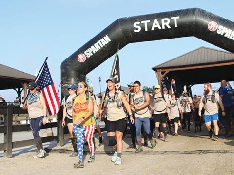 Cannon Crompton/sports@cherokeescout.com Team Oscar Mike takes on the Spartan Race course Saturday in Mill Spring.