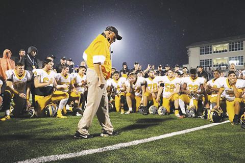 Coach David Gentry addresses the Bulldogs after winning one of his state championships. 