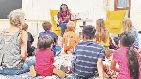 Nicole Wright/Staff Correspondent Guest reader Kristen George of One Dozen Who Care read as part of the Summer Reading Program at the Andrews Public Library on Aug. 7. George read selections from the Purel Miller African-American Book Collection to the young and young at heart crowd. Different community leaders were invited to read recently at each of the four branches in the Nantahala Regional Library system.