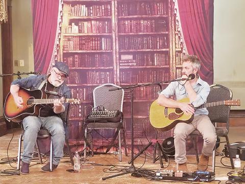 Nicole Wright/Staff Correspondent Local songwriters Zach Kilmer (right) and Troy Underwood entertain the crowd on June 11 at the Valleytown Cultural Arts Center in Andrews with stories behind their music.