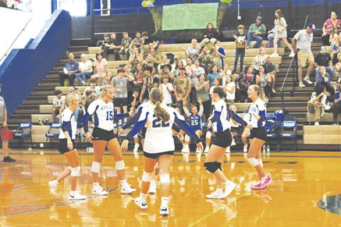 Cannon Crompton/sports@cherokeescout.com The Lady Eagles celebrate scoring a point against Andrews in their match on Sept. 10. The student section can be seen in the background celebrating as well.
