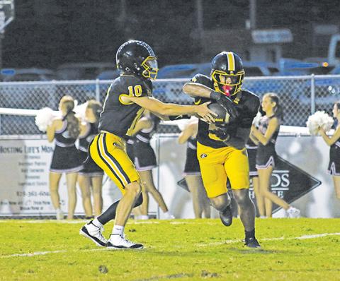Cannon Crompton/sports@cherokeescout.com Murphy quarterback Brady Grant hands the ball off to Cameron Clem on Friday night.