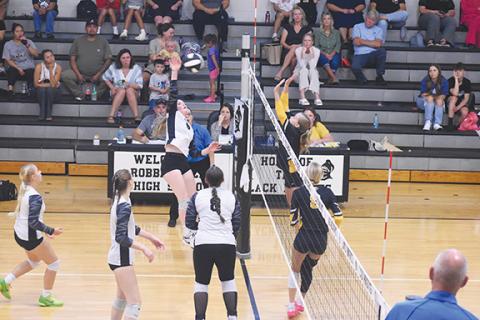 Cheyanne Geyer/Contributing Photographer  Murphy’s Jayda Holley (right) looking to leap and block a spike from Robbinsville’s Daphne Barlow (left) in their match on Aug. 27.