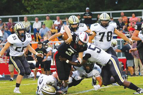 Cannon Crompton/sports@cherokeescout.com Andrews quarterback Everett Tatham runs into Hayesville’s defensive line on Sept. 6.