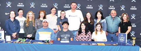 The News Observer Zechariah Prater (seated, middle) signed his letter of intent to run track at Charleston Southern School on April 12. He is surrounded by family, some from Hiwassee Dam.
