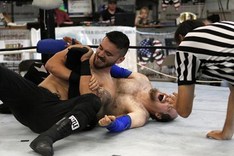 Cannon Crompton/sports@cherokeescout.com Flex Ferguson puts Frodo in a leg lock in the opening match Saturday. 