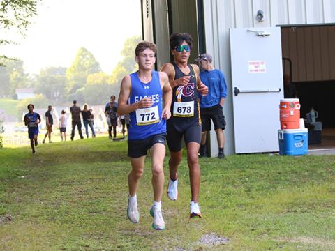 Cannon Crompton/sports@cherokeescout.com Ethan Russell (left) of Hiwassee Dam and Ogana Swimmer (right) of Cherokee run neck and neck at the first meet of the season in Hayesville on Aug. 21.