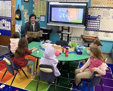 David Brown, who heads up the Rotary Reads program with the Rotary Club of Murphy, reads a book donated to Murphy Elementary School kindergarten students last year.