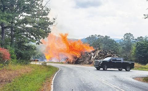Photos by Bill Belian/Contributing Photographer  Fire departments responded to Taylor Henson and Gold Branch roads off of Blairsville Highway on Sept. 25 to extinguish a massive wood pile on fire. The wood was collected as a result of tree removal from road construction in the area.