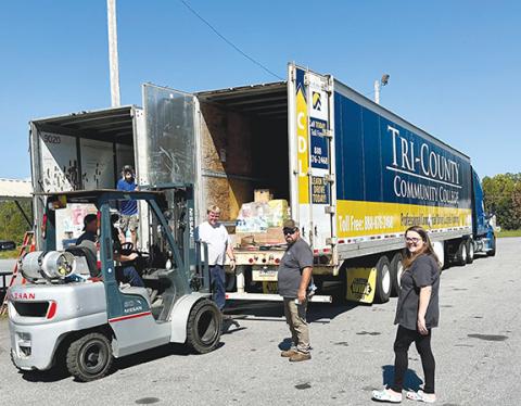 Aiden McCoy Williams/Staff Correspondent Tri-County Community College volunteers load semi trucks to deliver supplies to the Asheville area Saturday.