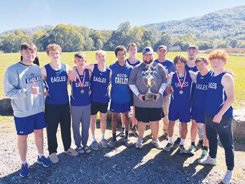Melissa Hawley/Contributing Photographer The Hiwassee Dam High School proudly holds their conference championship trophy after the win in Swain County on Saturday. The team is (from left) Brock Hyde, Jonah Dockery, Ethan Russell, Luke Harbin, Xavier Johnson, Travis Allen, Coach Josh Barton, Coach Andy Russell, Oscar Page, Avery Taylor, Maverick Hawley and Abel Penland.
