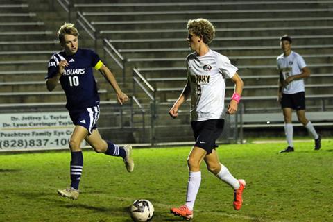 Cannon Crompton/sports@cherokeescout.com Tyler Payne (right) of Murphy moves the ball downfield while Landen Spies (left) of Tri-County Early College runs with him defending during their match on Oct. 10.