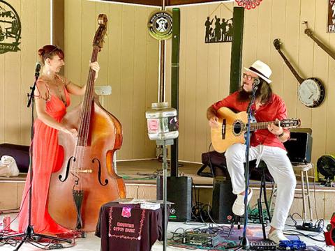 Mountain Gypsy musician duo Curtis (right) and Kim Jones (left) perform at J&J’s Getaway Campground & RV Park in Beaver Dam on Aug. 31.