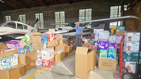 Photos by Aiden McCoy Williams/Staff Correspondent Volunteer and pilot Gayland Trull with supplies received at Western Carolina Regional Airport in Andrews through the Cherokee Clay Food Alliance.