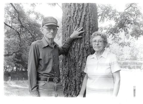 Howard and Louise Whitehouse stand under the walnut tree where they were married in 1941.The couple purchased the homeplace in 1961 and permanently moved to Andrews to retire years later.  
