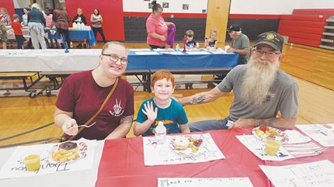 Photos by Nicole Wright/Staff Correspondent Families enjoyed breakfast with their veterans Andrews Elementary School on Friday as part of the annual Veterans Day Ceremony put on jointly with Andrews High School. From left are Scott’s daughter, Amanda Ramler; her son and second-grader Harrison Severance; and proud grandfather and Andrews VFW Post 7620 commander and Marine veteran Scott Ramler.