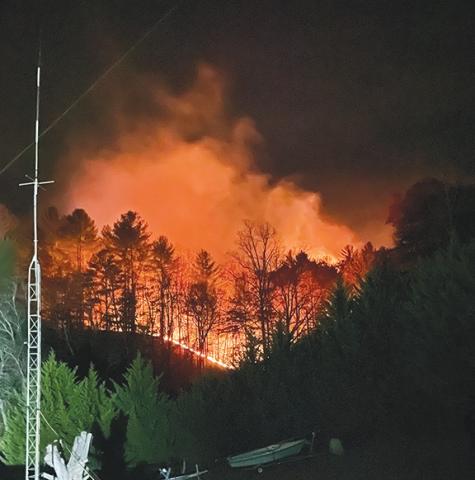 Ed Figueroa/Contributing Photographer Fire lights the early morning sky in the Oakwood Estates area of western Cherokee County early Sunday morning. The blaze burned 24 acres.