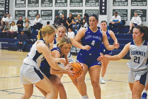 April McNabb/Contributing Photographer Brooklyn Hyde of Hiwassee Dam fights with the ball past a defender to maintain possession against Summit Charter on Friday night.