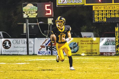 Cannon Crompton/sports@cherokeescout.com Murphy quarterback Brady Grant scrambles out of the pocket and looks to make a pass in their game against Andrews on Oct. 25.