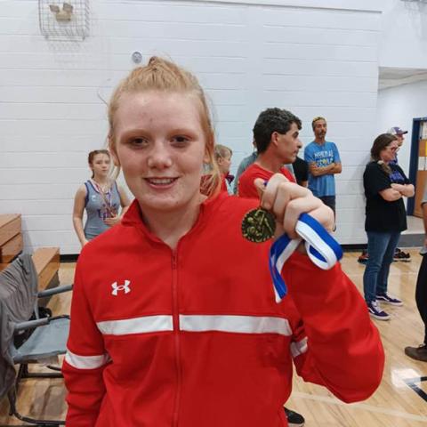 Andrews Middle School wrestler Sissy Ashe proudly holds her first place medal after going 3-0 with three pins at the first tournament of the season in Hiawassee, Ga.