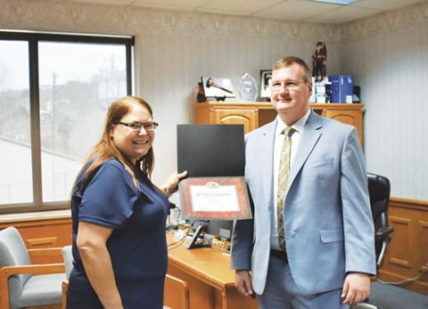 Bill Belian/Contributing photographer Tracy Davis accepts a Certificate of Appreciation from Mayor Tim Radford on Nov. 4 for her many hours of volunteer work and dedication.