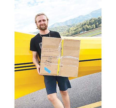 Aiden McCoy Williams/Staff Correspondent Volunteer Noah Lescalleet helps Cherokee Clay Food Alliance unload supplies at Western Regional Airport in Andrews to be delivered to areas affected by Hurricane Helene.